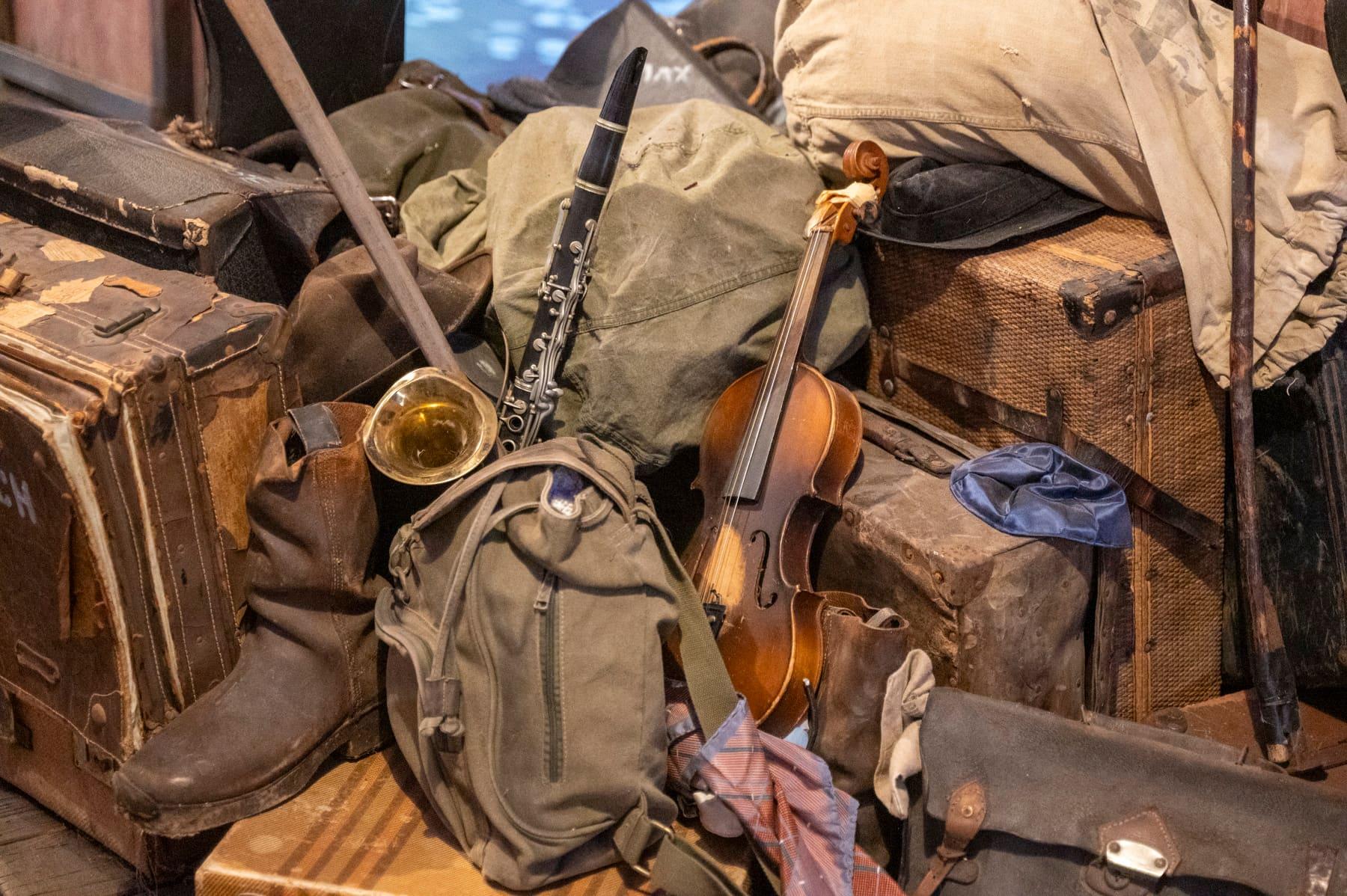 Violin arranged among worn luggage and personal belongings