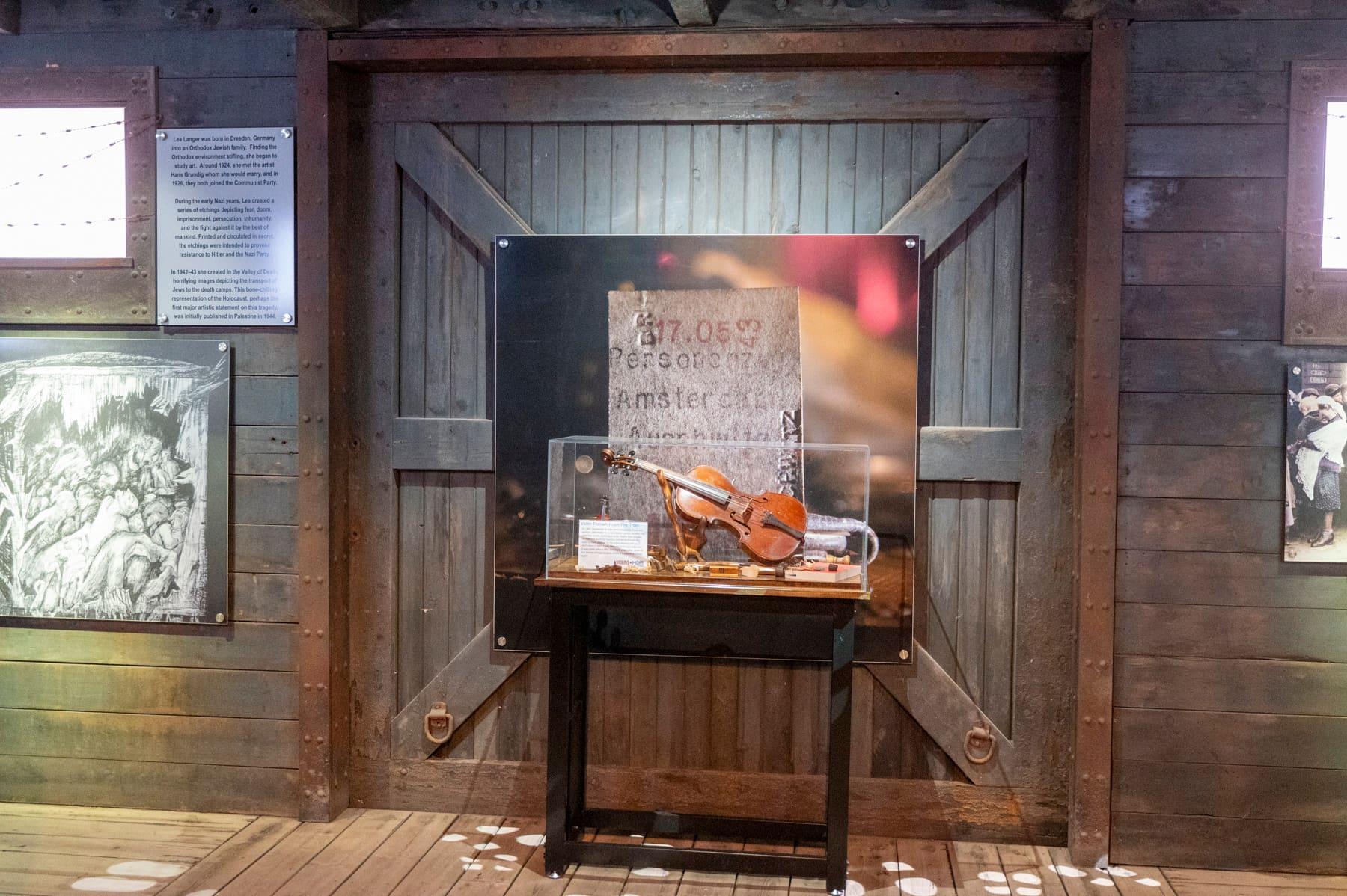 Violin displayed in a wooden niche with historical interpretation