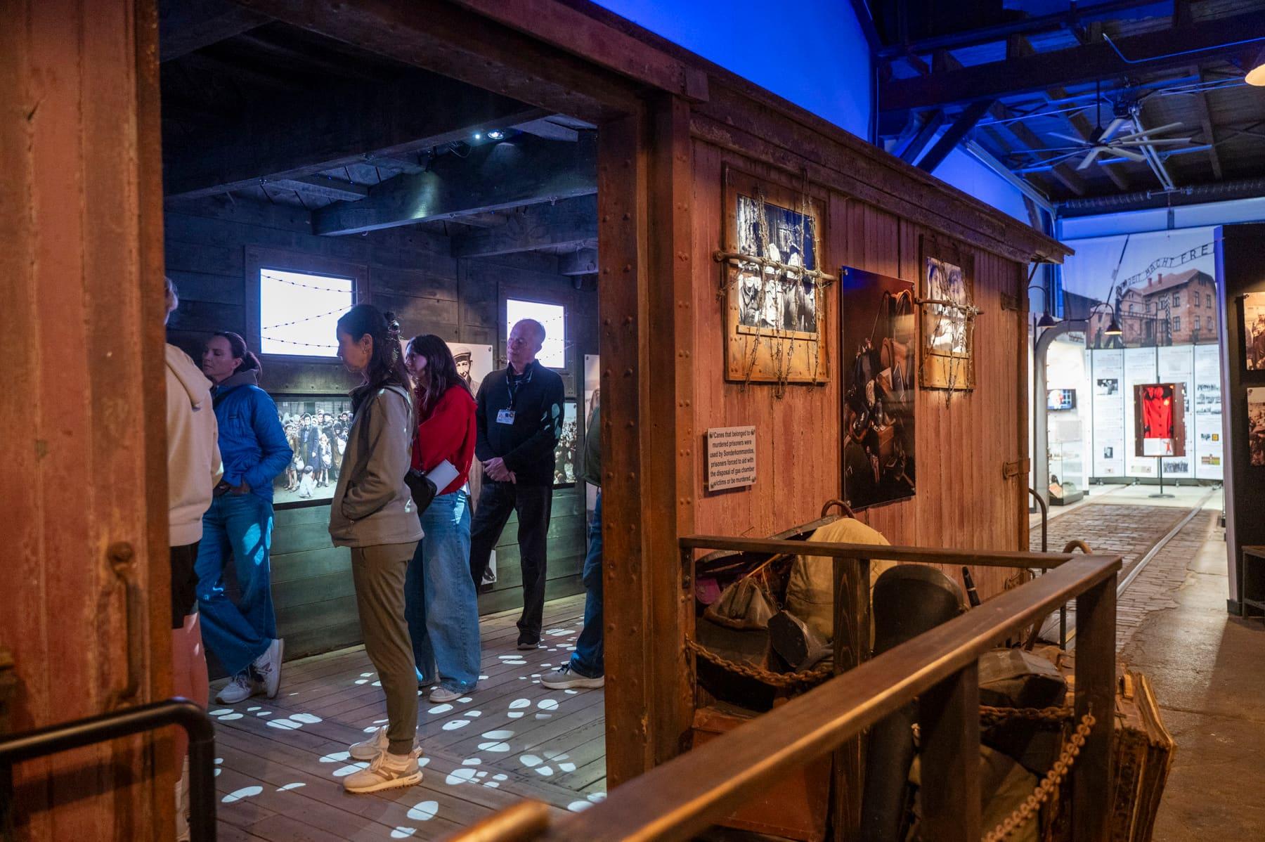 Visitors watching a multimedia display inside the reconstructed railcar