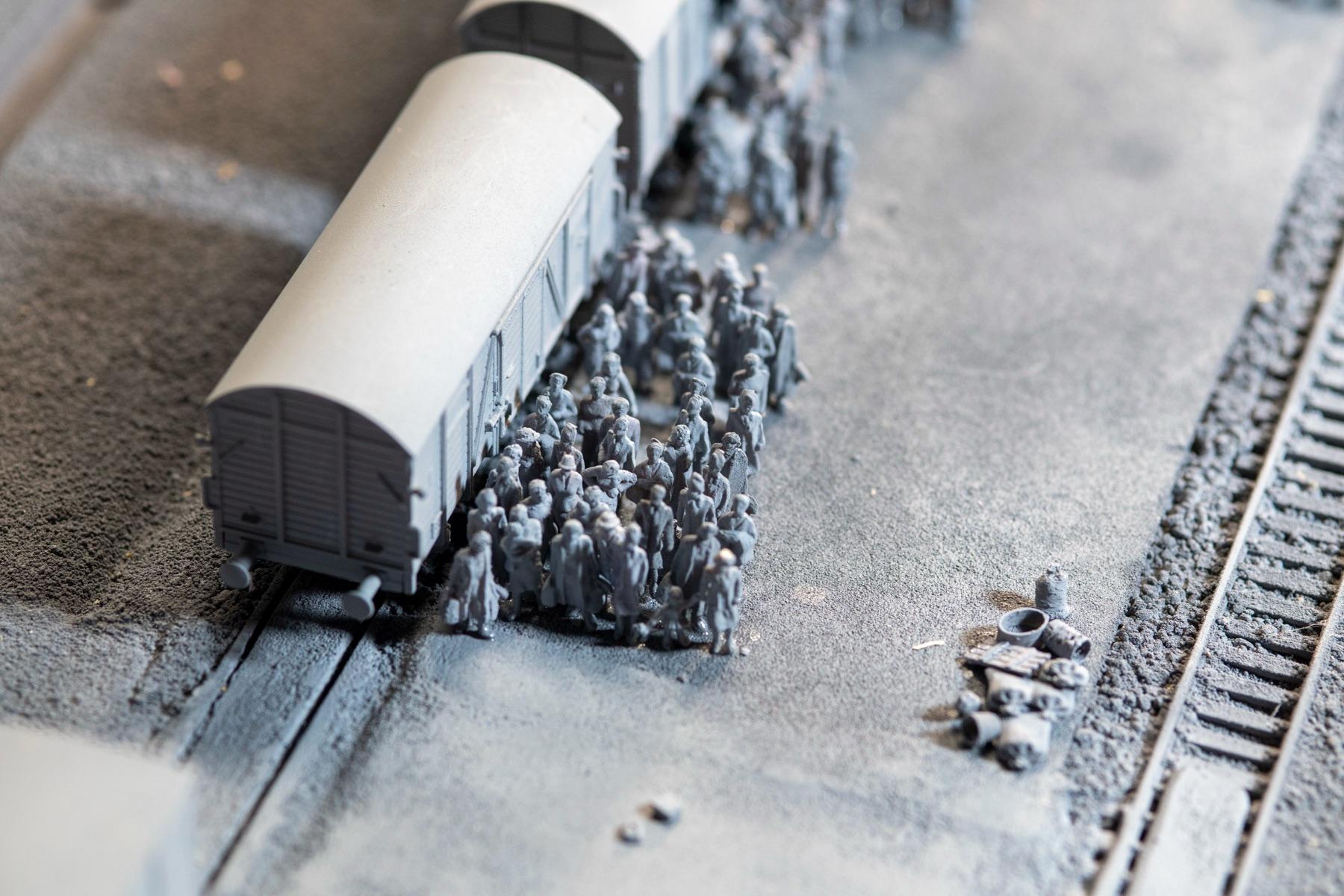 HO-scale model of people gathered beside cattle cars at the Auschwitz-Birkenau arrival-area reconstruction