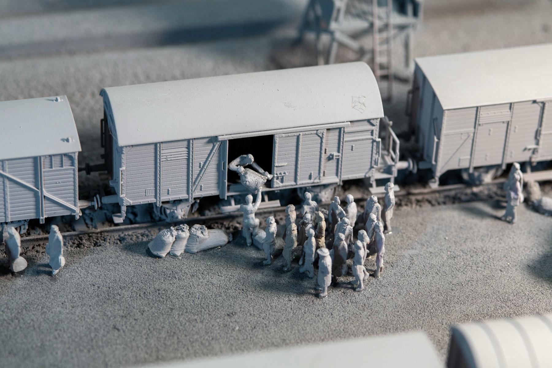 HO-scale model detail showing an open cattle car and figures at the Auschwitz-Birkenau arrival-area reconstruction