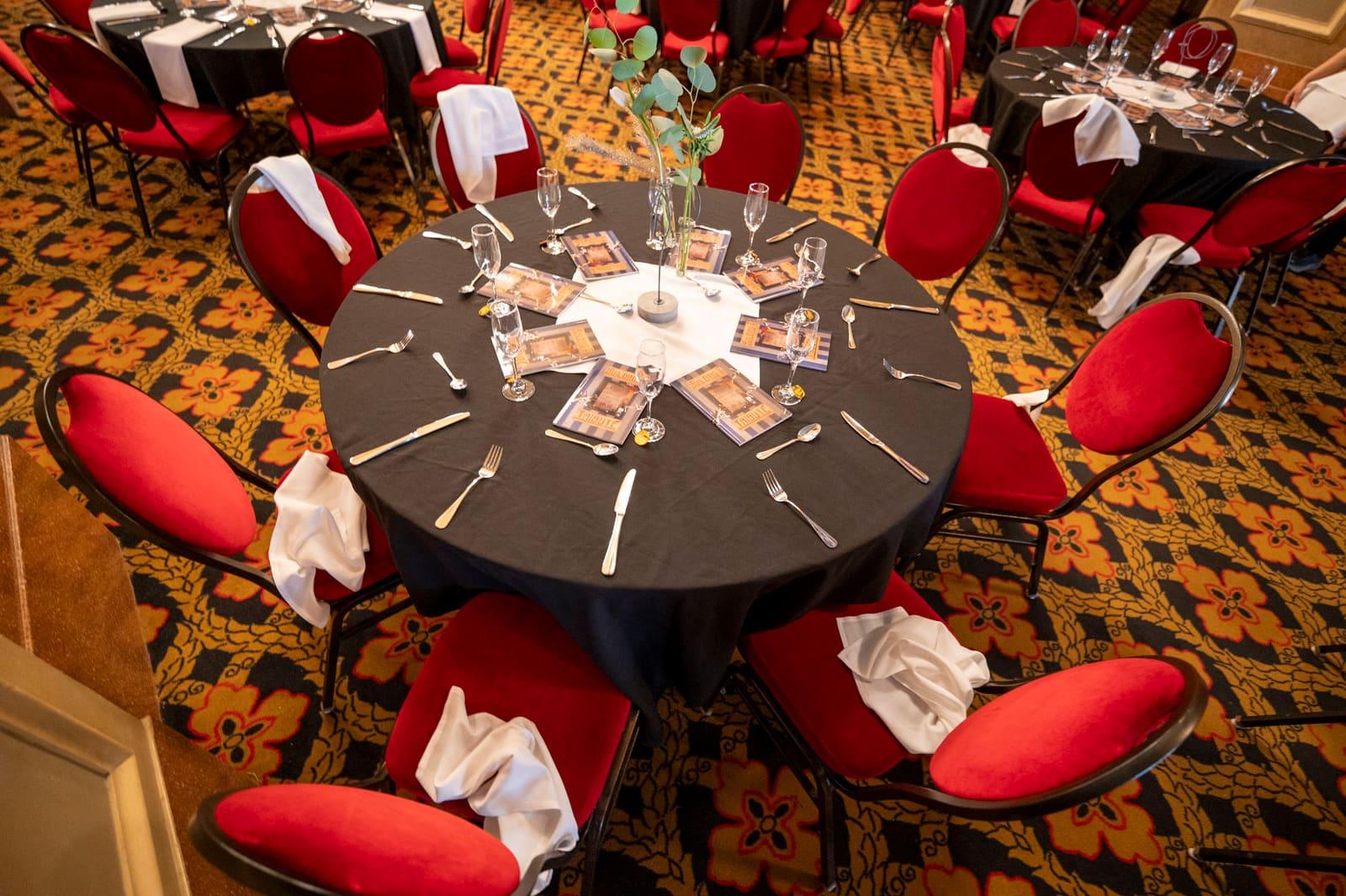 An overhead view shows an empty round banquet table with place settings.