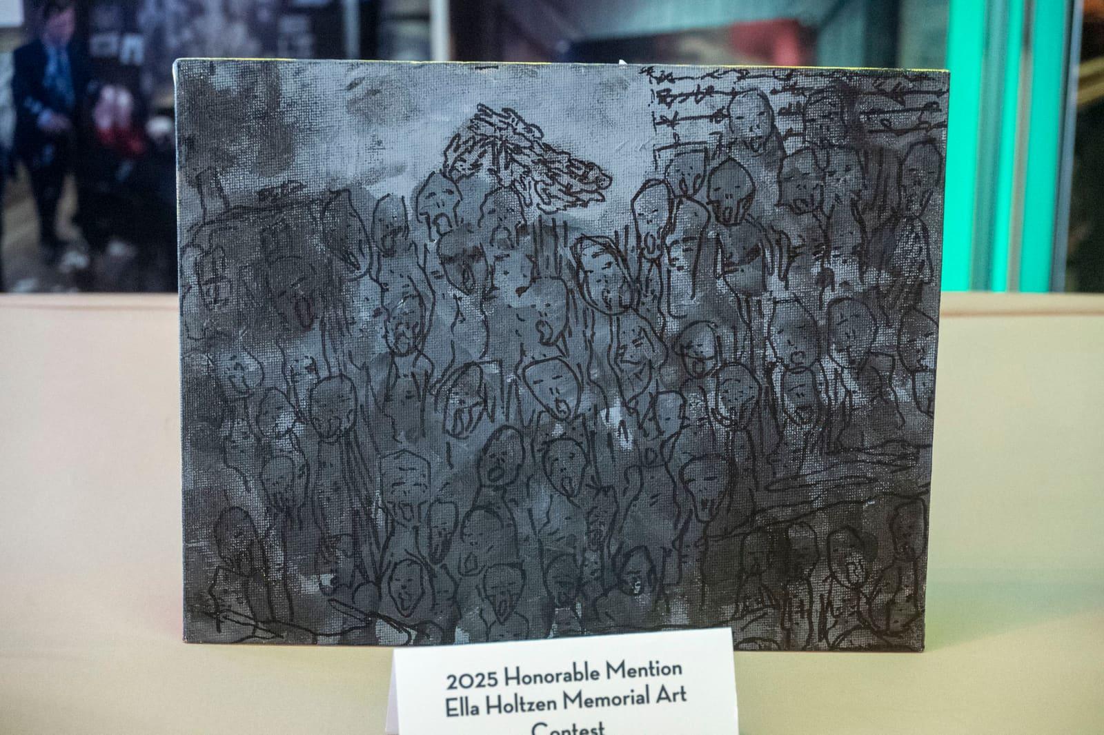 A dense black-and-white drawing of overlapping figures rests on display.