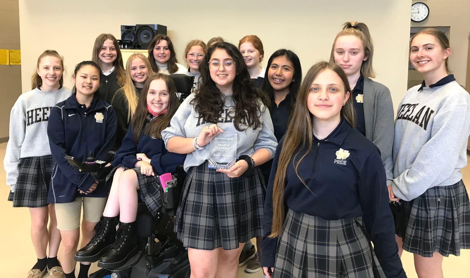 Students pose together in a classroom.