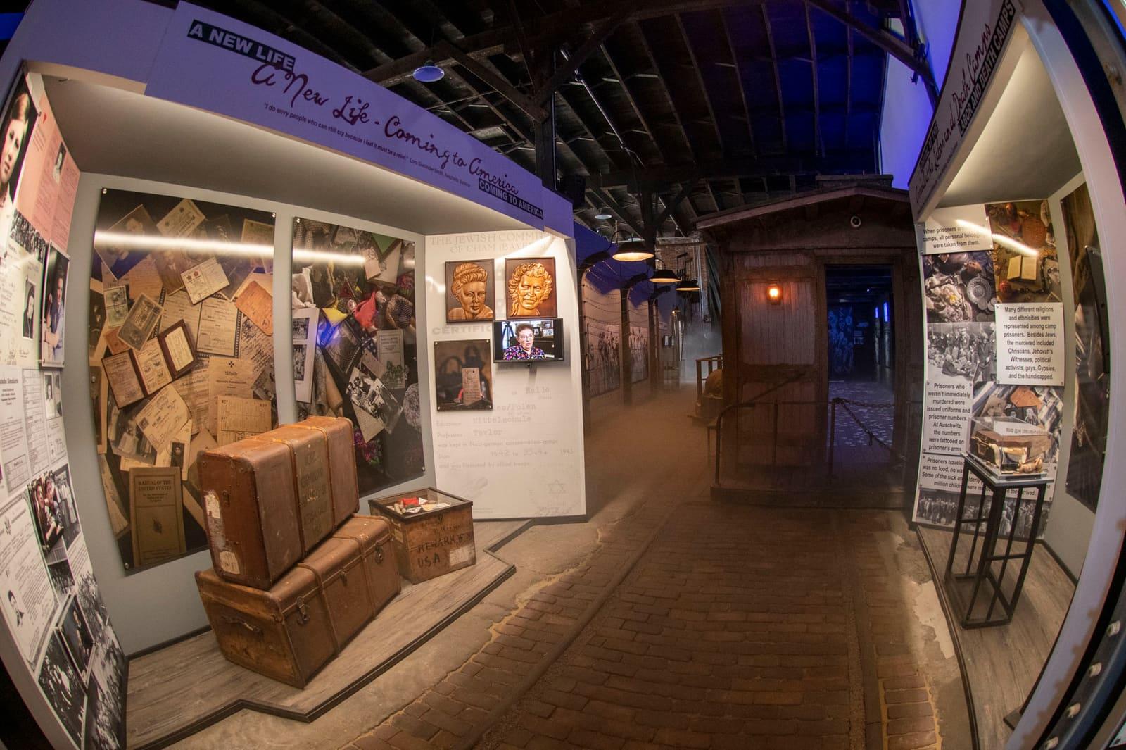 Wooden crates and historical displays line an indoor exhibit walkway.