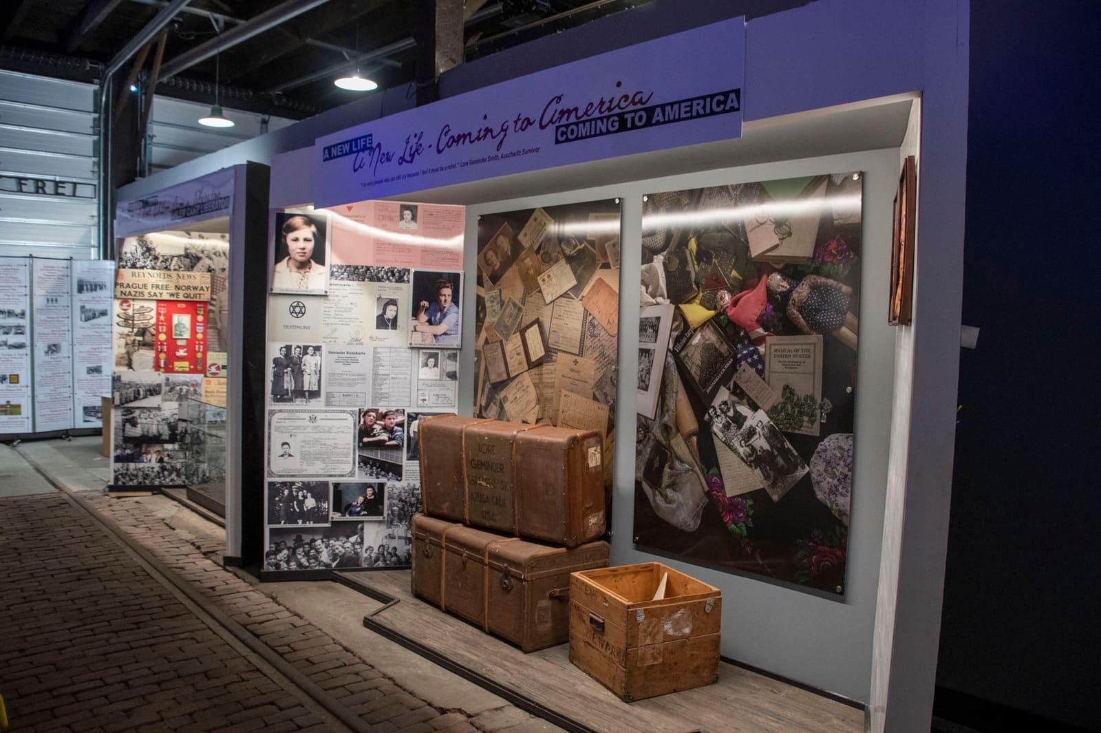 A historical display combines photographs, text panels, and wooden crates.