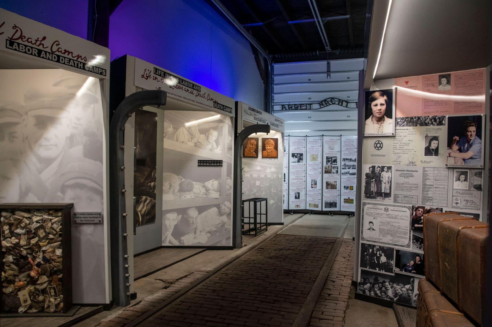 An exhibit entrance is lined with historical panels and stacked crates.