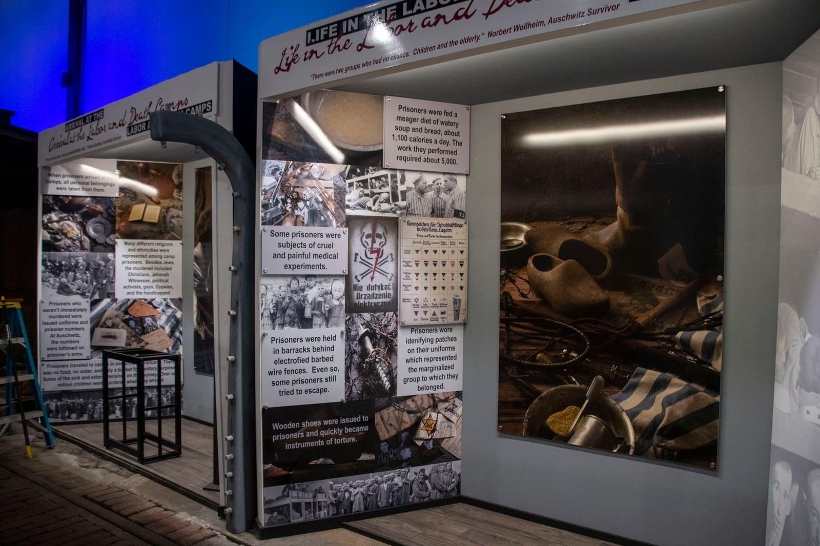 Historical panels flank a glass case filled with worn shoes.