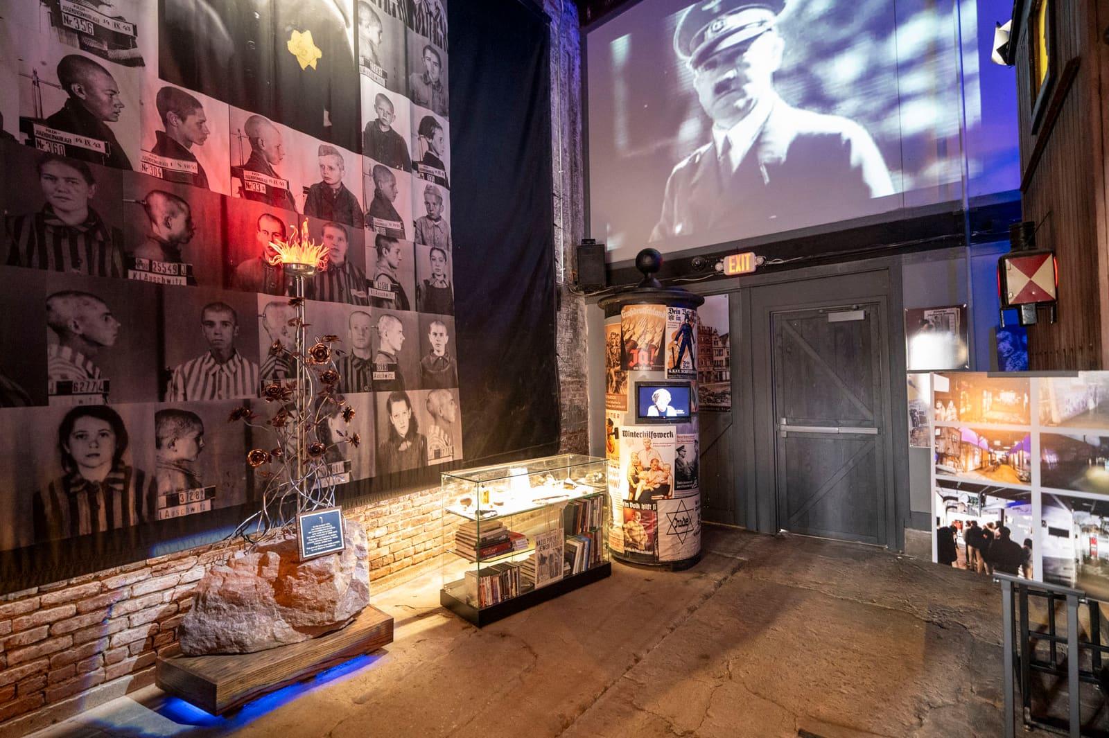 Historical portraits, cases, and artifacts fill a blue-lit exhibit room.
