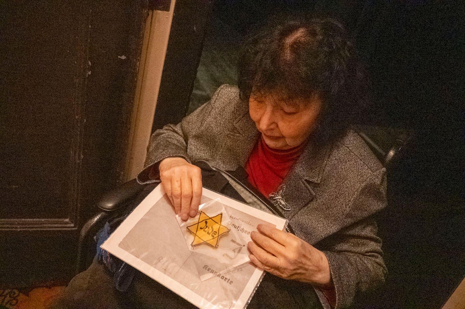 A seated adult examines a paper bearing a yellow star.