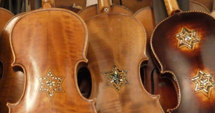 Close-up of wooden violins decorated with Star of David inlays.