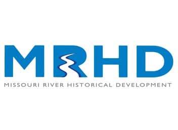 Missouri River Historical Development logo with large blue “MRHD” letters, a white river curve, and a gray name line.